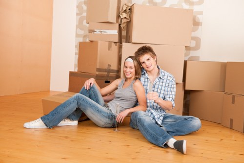 Professional movers handling furniture in Fulham storage facility